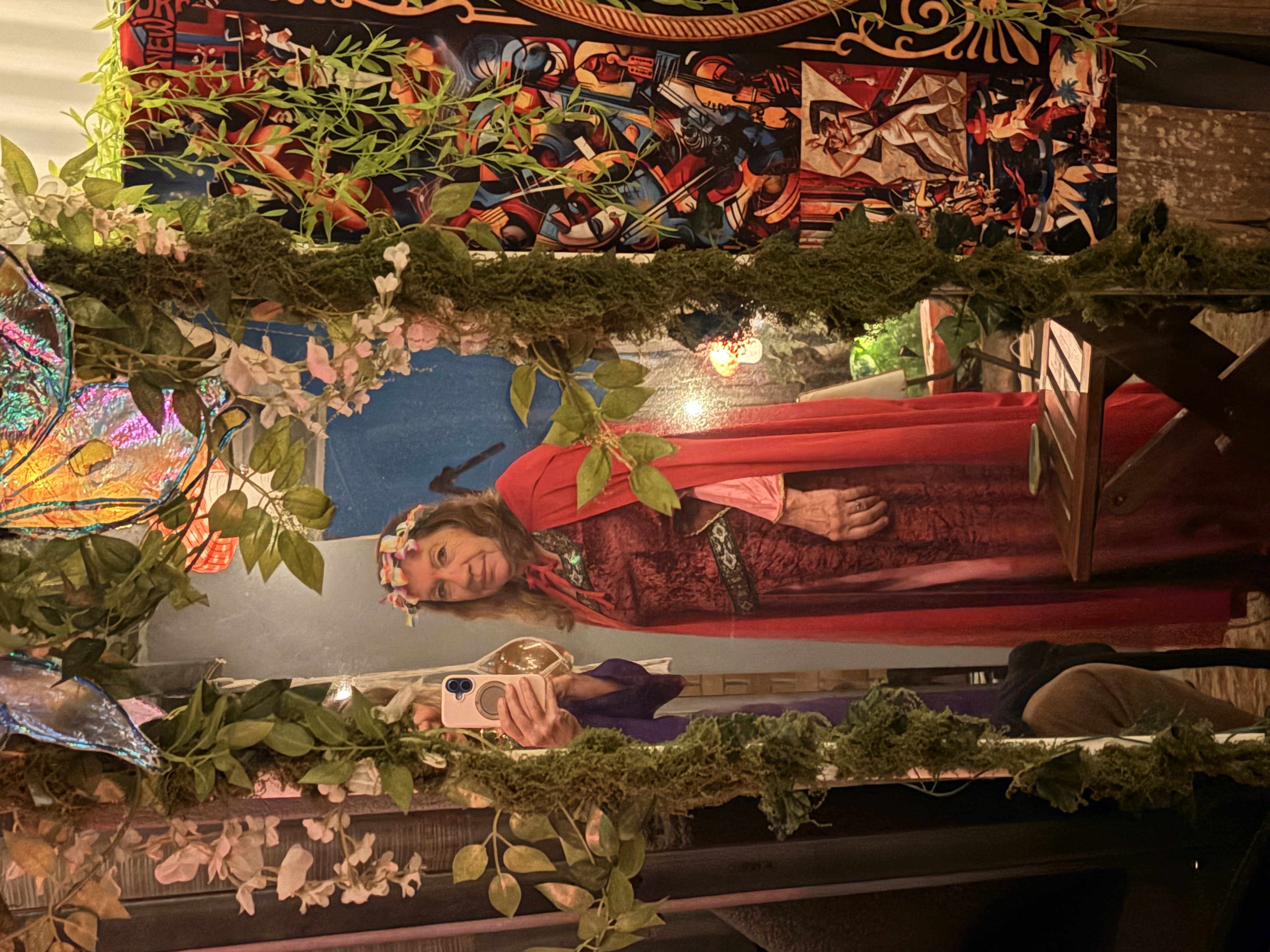 Guest in a red cloak in the foliage mirror