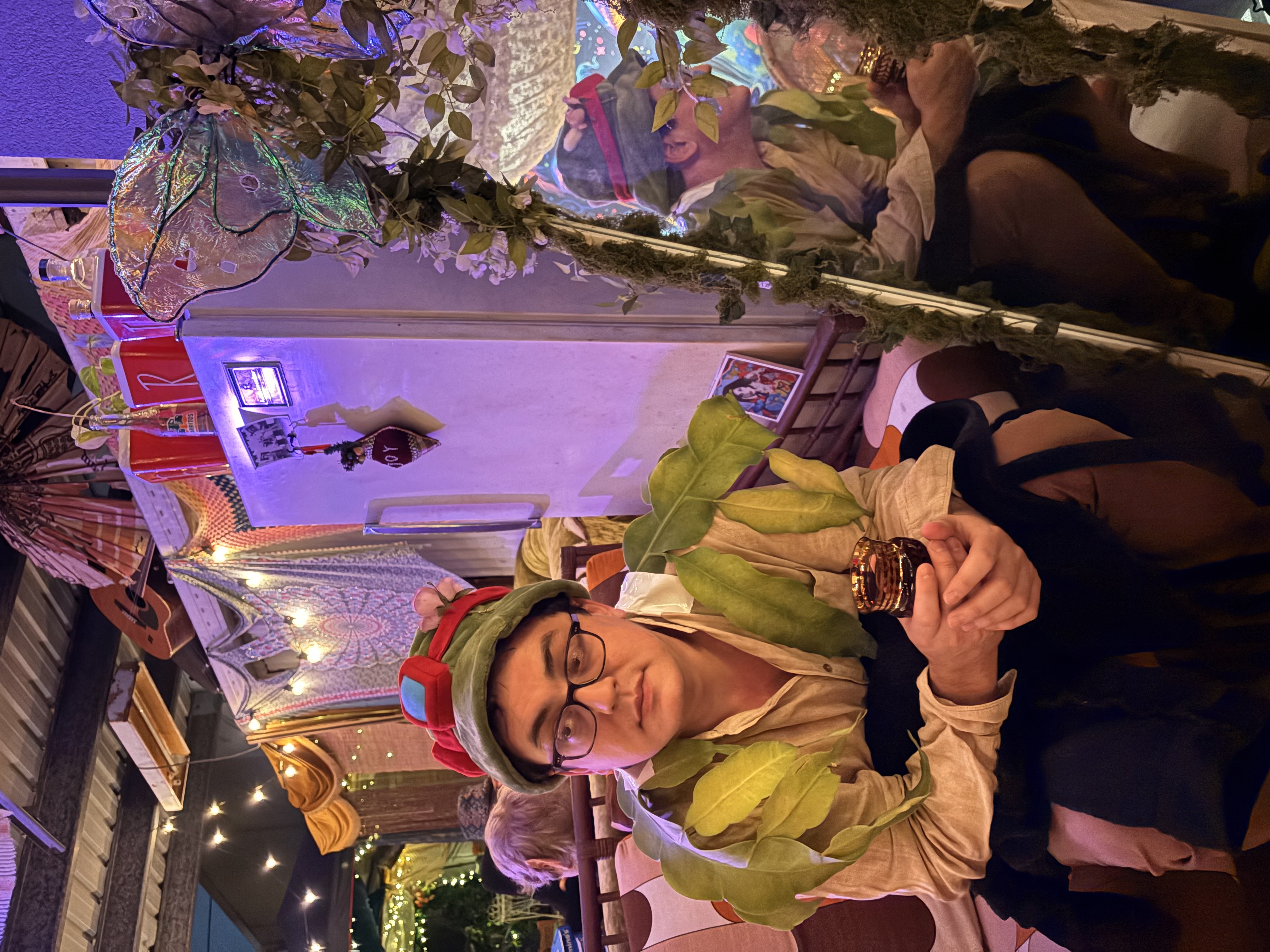 Guest in a leaf garland and frog hat